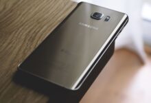 A sleek Samsung smartphone placed on a wooden surface, capturing modern elegance.