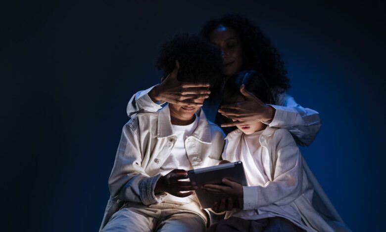 A mother oversees her children using a tablet, emphasizing safety and supervision in digital media use.