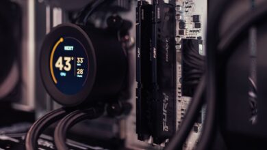 Detailed view of a gaming PC's interior featuring RAM and a digital CPU cooler display.