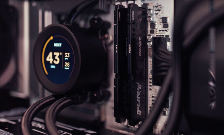 Detailed view of a gaming PC's interior featuring RAM and a digital CPU cooler display.