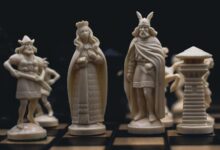 Detailed close-up of intricately carved chess pieces on a chessboard, evoking a medieval theme.