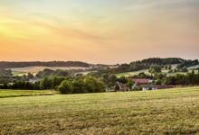 Peaceful rural landscape in Zbraslavice, Czechia at sunset with rolling hills and farmland.