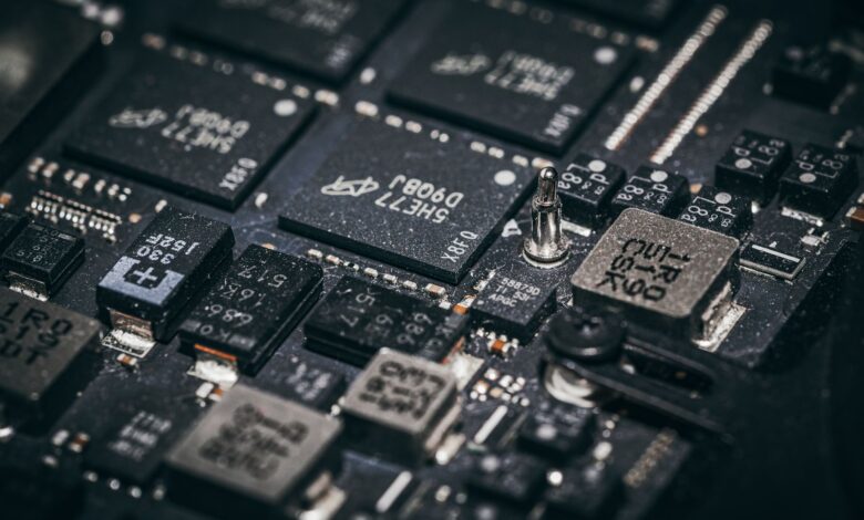 Detailed close-up of electronic microchips on a circuit board, showcasing technology and engineering intricacies.