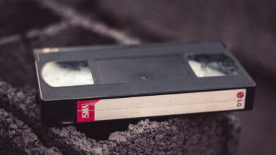 Close-up of a vintage VHS tape resting on a textured surface, offering nostalgic appeal.