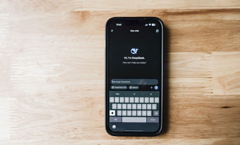 A smartphone on a wooden table showing an AI chatbot interface called DeepSeek.
