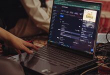 A person setting up a live stream on a laptop, emphasizing technology and connectivity.