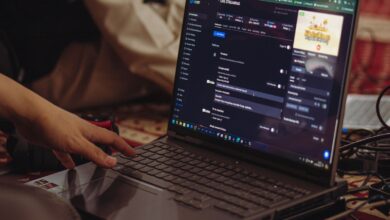 A person setting up a live stream on a laptop, emphasizing technology and connectivity.
