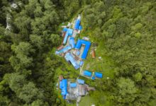 Explore Ghandruk, Nepal from above. This vibrant village is nestled in dense forests, showcasing stunning architecture.