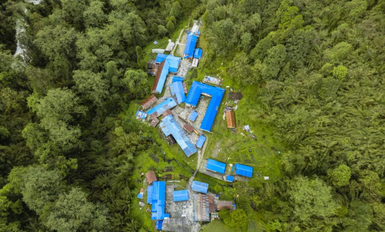 Explore Ghandruk, Nepal from above. This vibrant village is nestled in dense forests, showcasing stunning architecture.