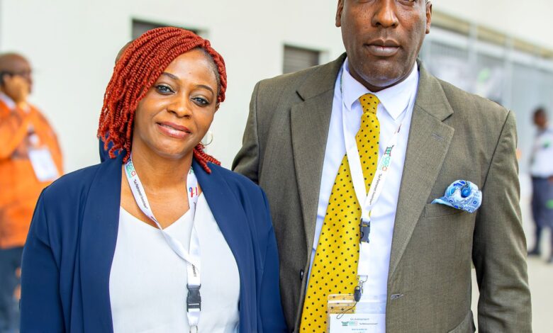 Elegant African couple attending a business conference in professional attire, showcasing cooperation and networking.