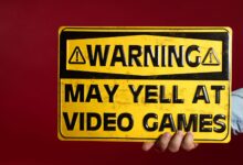 Yellow warning sign humorously cautioning about potential yelling at video games.