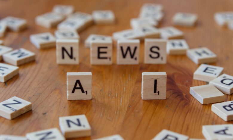 Wooden Scrabble tiles spelling 'AI' and 'NEWS' for a tech concept image.
