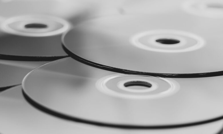 Monochrome close-up view of stacked optical discs. Minimalist design in grayscale.