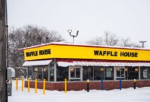 A Waffle House building covered in snow, showcasing winter atmosphere and architecture.