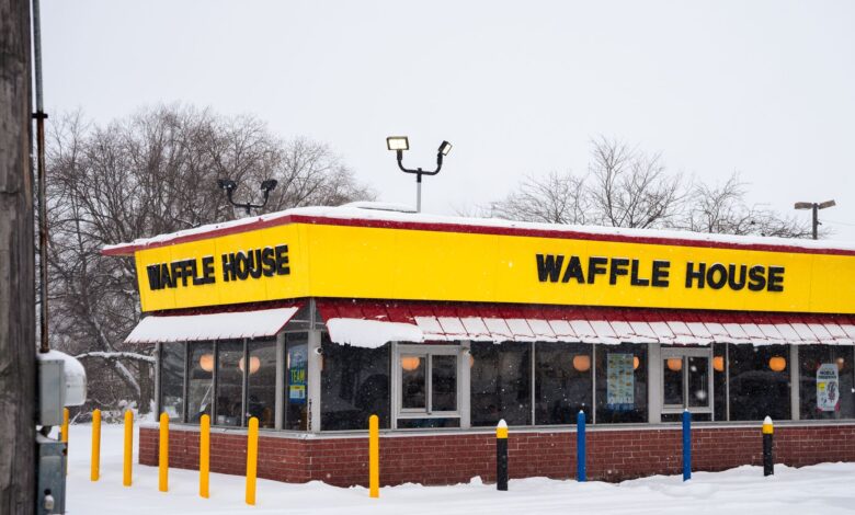 A Waffle House building covered in snow, showcasing winter atmosphere and architecture.