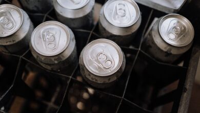Top-down photo of aluminum beverage cans with condensation in a crate.