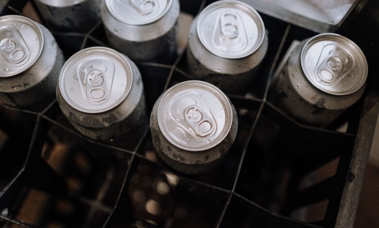 Top-down photo of aluminum beverage cans with condensation in a crate.
