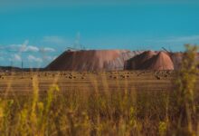 Vast field landscape with salt mines in Salihorsk, Belarus under a clear blue sky.