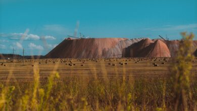 Vast field landscape with salt mines in Salihorsk, Belarus under a clear blue sky.