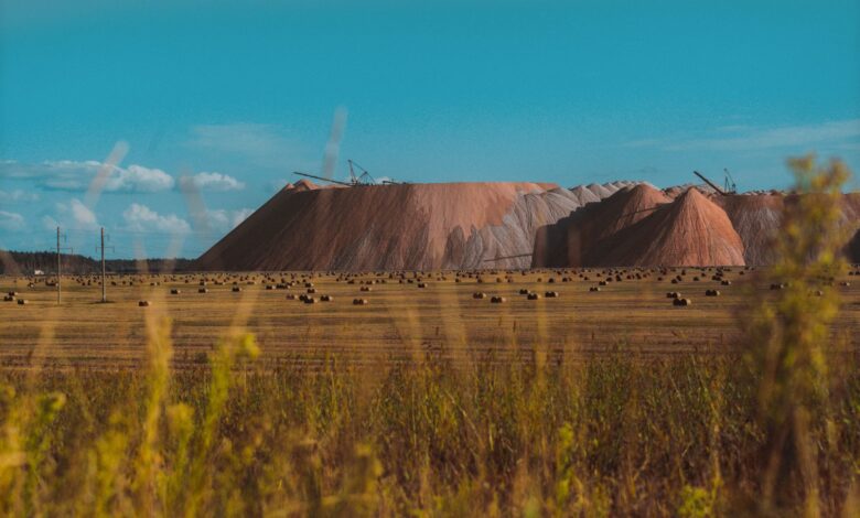 Vast field landscape with salt mines in Salihorsk, Belarus under a clear blue sky.