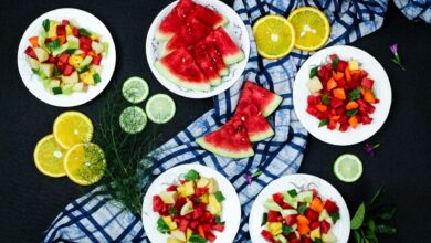 Top view of a vibrant and healthy fruit salad arrangement on a black background.