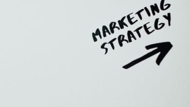 Close-up of handwritten 'Marketing Strategy' text with an arrow on white background.