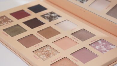 Close-up of a versatile eyeshadow palette featuring nude and colorful shades for eye makeup.
