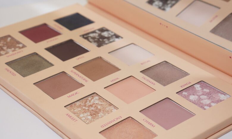 Close-up of a versatile eyeshadow palette featuring nude and colorful shades for eye makeup.