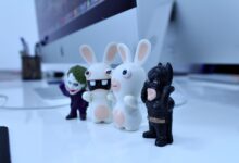 Close-up of various cartoon figurines on a modern desk setting, perfect for creativity-themed projects.