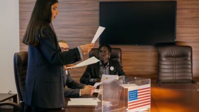 A diverse group of professionals engaged in a political discussion or meeting in an office setting.