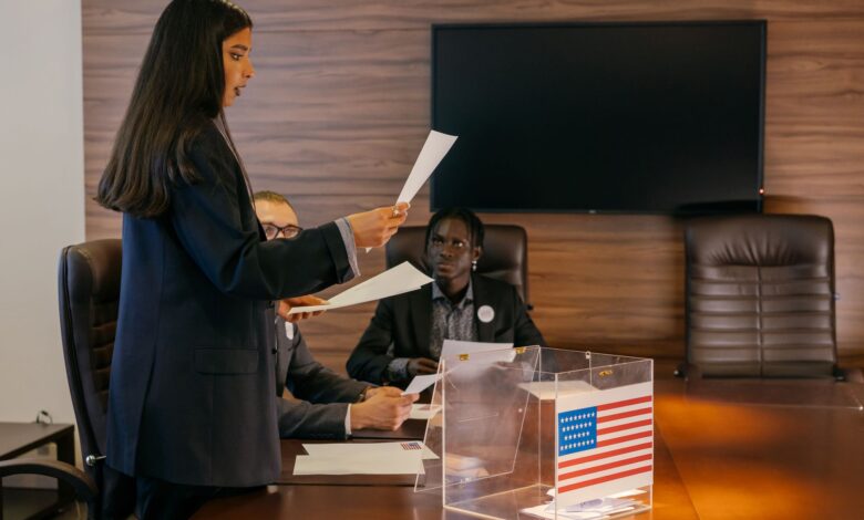 A diverse group of professionals engaged in a political discussion or meeting in an office setting.