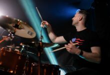 Dynamic image of a drummer playing passionately during a live rock concert.