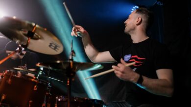 Dynamic image of a drummer playing passionately during a live rock concert.
