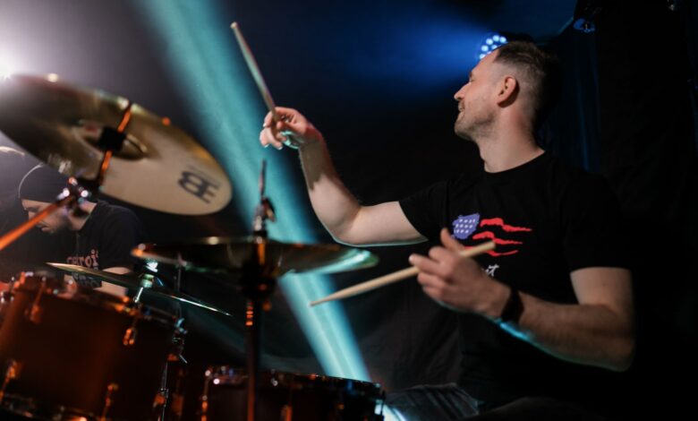 Dynamic image of a drummer playing passionately during a live rock concert.