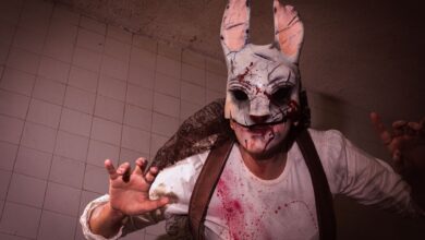 Close-up of a person in a bloody rabbit mask with ominous lighting.