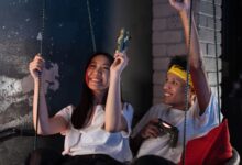 Lively scene of young Asian friends having fun playing video games together indoors.
