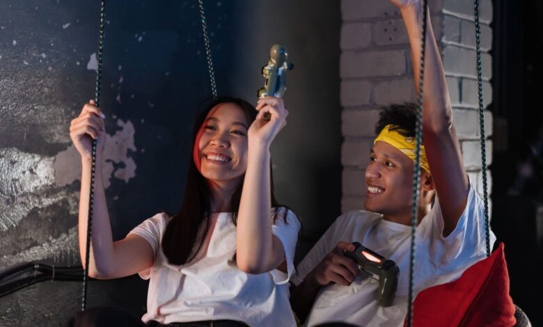 Lively scene of young Asian friends having fun playing video games together indoors.