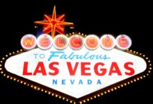 Bright neon 'Welcome to Las Vegas' sign glowing against the night sky, representing the vibrant city life.