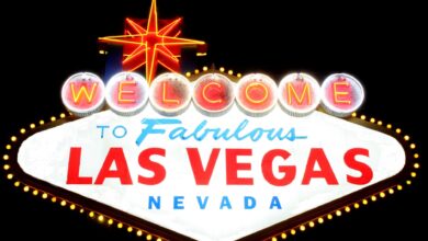 Bright neon 'Welcome to Las Vegas' sign glowing against the night sky, representing the vibrant city life.