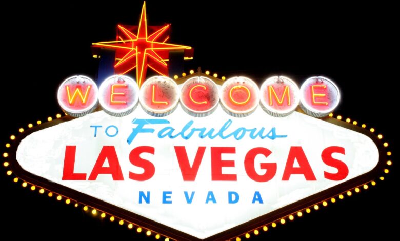 Bright neon 'Welcome to Las Vegas' sign glowing against the night sky, representing the vibrant city life.