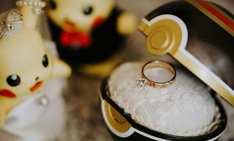 Whimsical Pokemon-themed engagement scene with ring in Pokeball and cute figures.