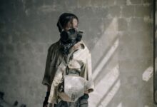A young person with a gas mask stands in a dilapidated building, evoking a post-apocalyptic scene.