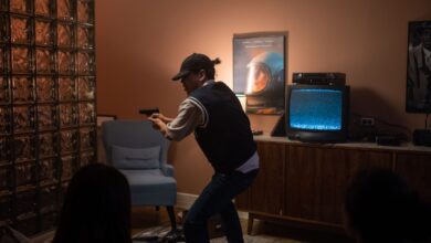Teens creatively engage in play, pretending to be in a suspenseful movie scene indoors.