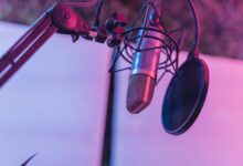 A close-up view of a microphone in a vibrant studio environment, ideal for podcasts and voice recording.