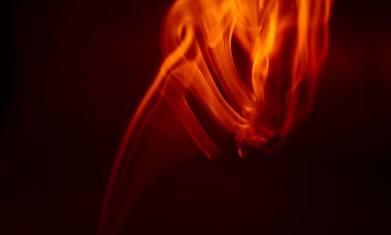 An abstract image capturing the dynamic and vibrant movement of flames with a dark background.
