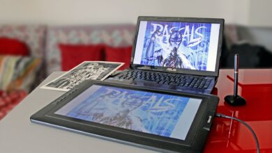 Digital drawing setup with laptop and tablet for modern art creation.