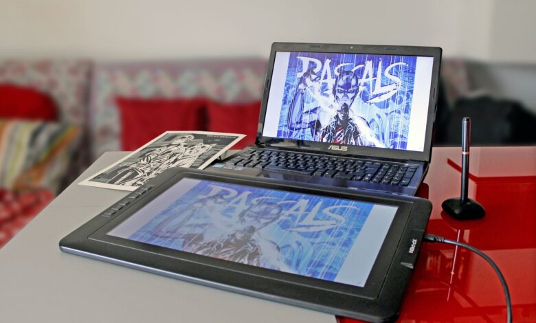 Digital drawing setup with laptop and tablet for modern art creation.