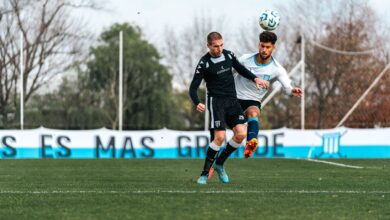 Two soccer players in action during an intense match, competing for the ball outdoors.