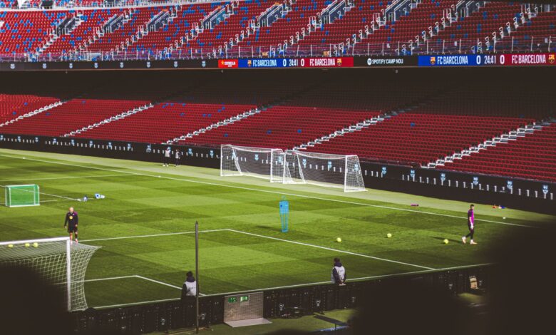 View of empty soccer field at FC Barcelona's Camp Nou with training equipment.