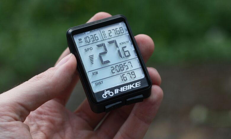 Detailed shot of digital bike speedometer displaying speed, distance, and time.